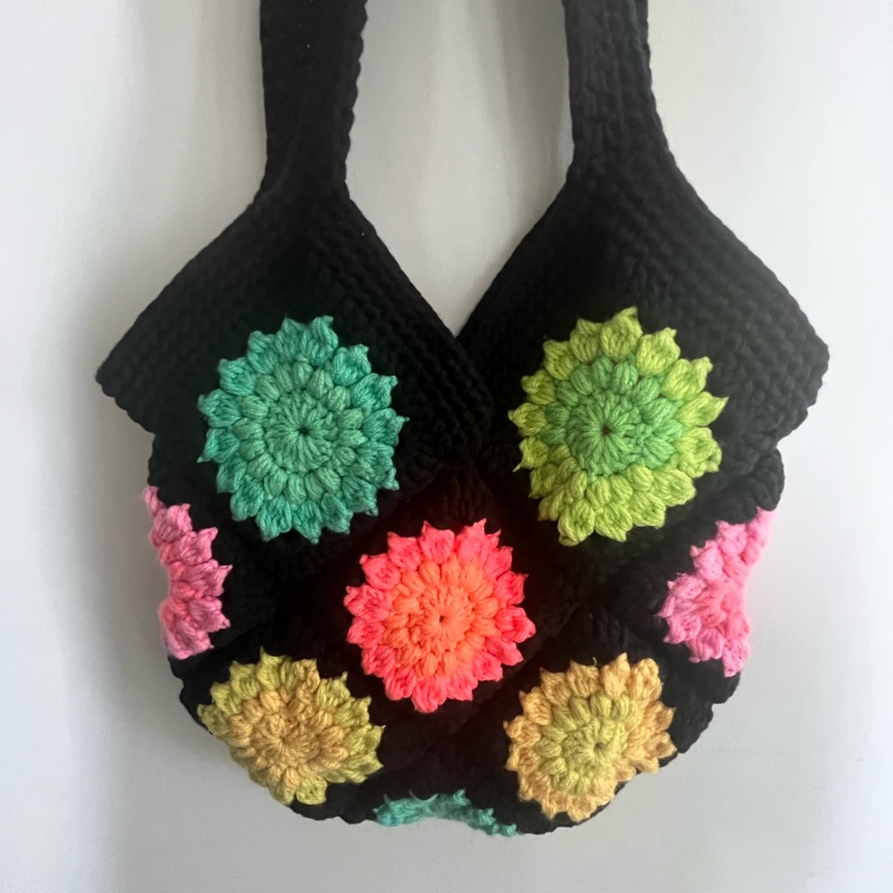 Knit black boho purse with multicoloured bright knit flower details